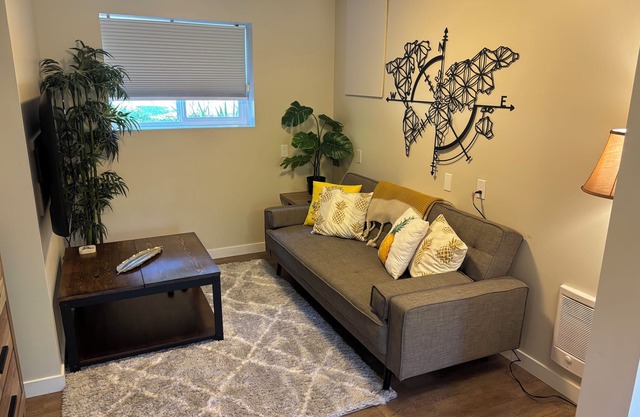 A bright and cozy 1-bedroom basement suite is nestled in a lush garden setting