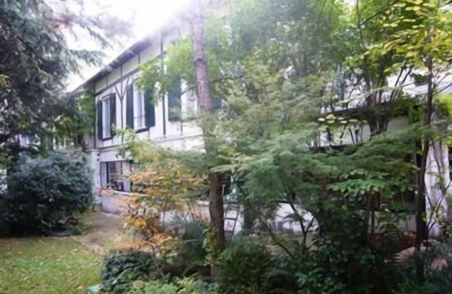 A HOUSE IN A GARDEN IN PARIS