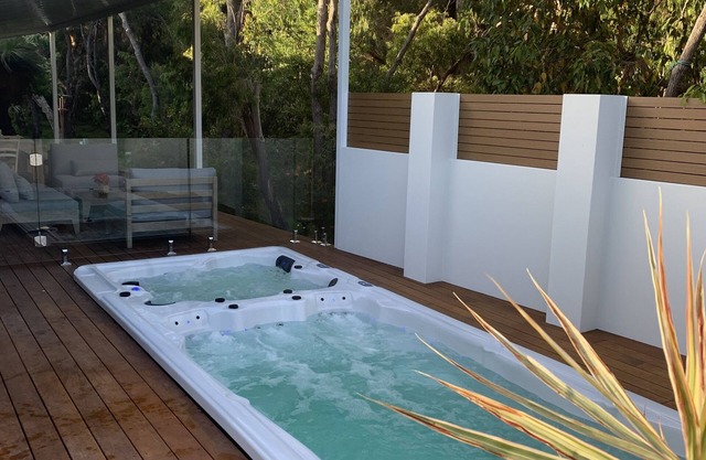 A nature haven within walking distance to beach/town with swim spa on the deck.