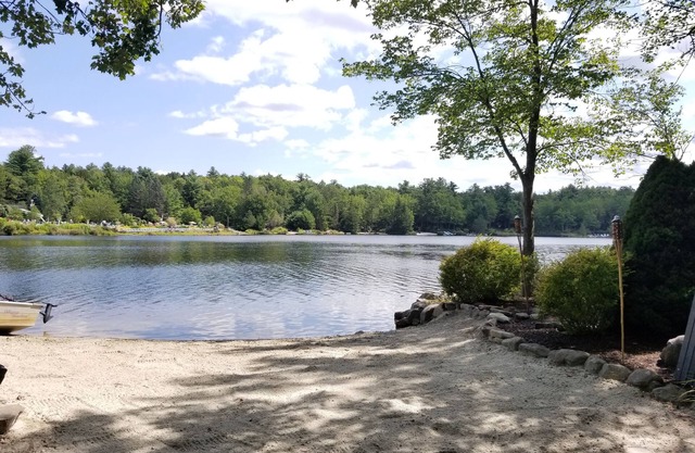 A quaint wooded lakefront home with private beach!