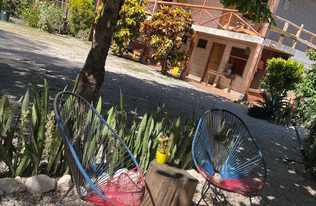 A rustic lodge surrounded by garden, nestled in a jungle setting - double Room 1