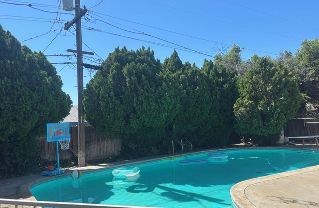 Beautiful Home in quiet neighborhood with a pool and close to stores & highways.