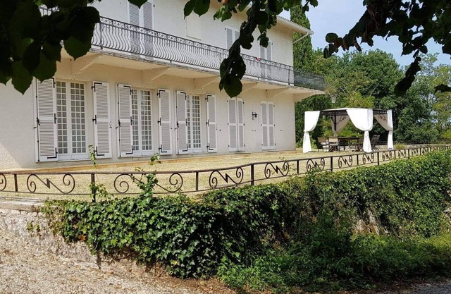 Colonial house surrounded by cliffs and trees