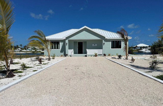 Deep water Canal front home w/dock across the street from the beach.