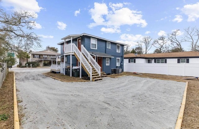"Delightful 2BR duplex: ocean steps away, close to attractions."