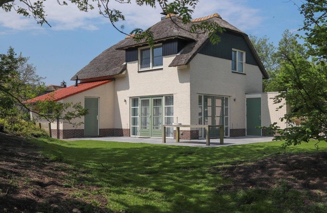 Detached dune villa with a spacious yard, bathtub, and two patios close to the beach at Beach Resort Makkum.