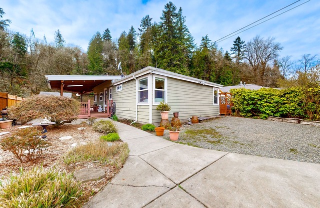 Dog-friendly riverfront home with patio, golf nearby, enclosed yard, & W/D