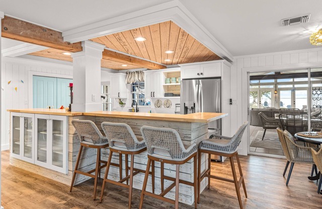 Dog-friendly waterfront home with outdoor kitchen, bar, firepit, & kayak launch