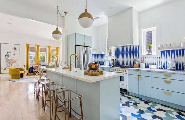 Enjoy colorful vibes, velvet furniture, and a showstopper kitchen with funky blue hand-dyed tiles.