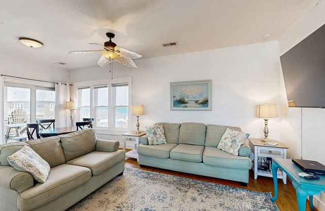 Fun-filled vacation home steps from beach with outdoor pool, AC, W/D, & balcony