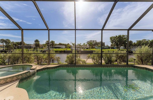 GoGo House. Charming 2 BR, 2 BA, Waterfront Vacation Rental in Port Charlotte, FL, w/Heated Private Pool & Spa