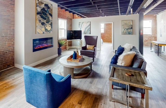 Industrial-chic loft with exposed brick, great kitchen & fireplace