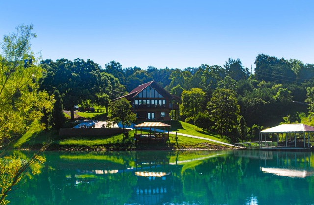 Lakefront cabin with views, boat ramp, dock, hot tub, & free attraction tickets