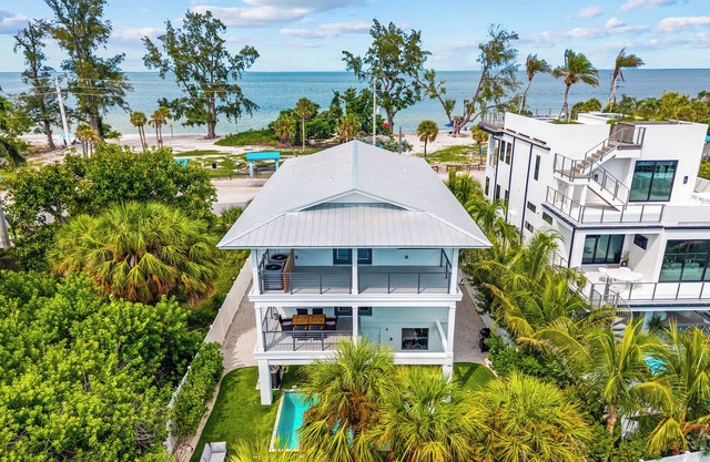 Modern 4BR Coastal Retreat with Water Views, Steps to the Beach + Golf Cart