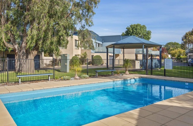 Modern townhouse, walking distance to shops and beach, with a pool!