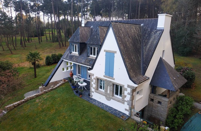 Neo-Bretonne house in wooded grounds.