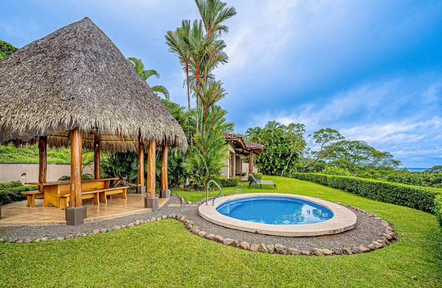 Palm-lined oasis with mountain & ocean views, a pool, hammock, & soaking tubs