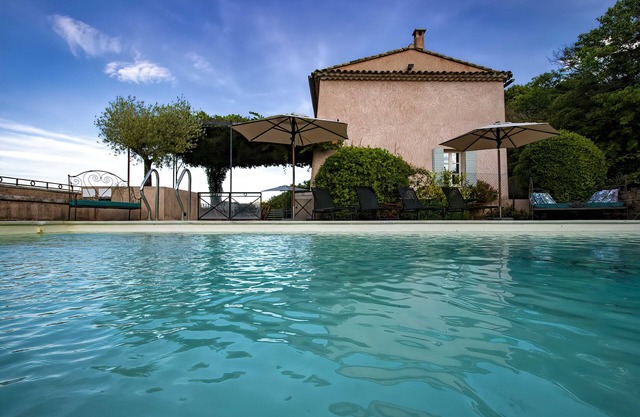 Restored farmhouse with heated pool and landscaped gardens.