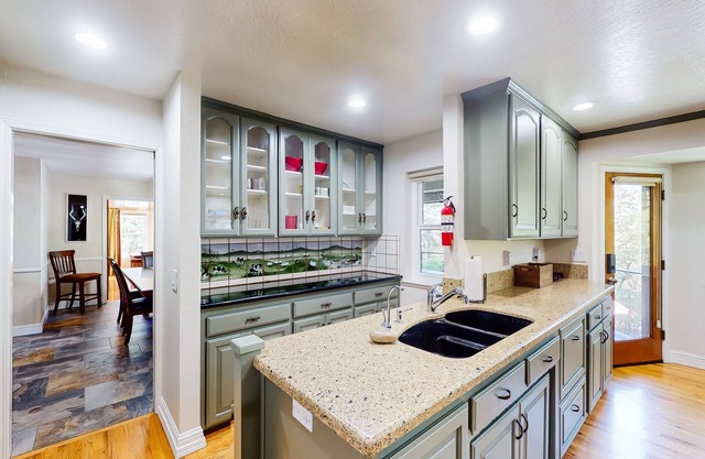 Serene retreat with pool, hot tub, basketball court, wood fireplace, & gas grill