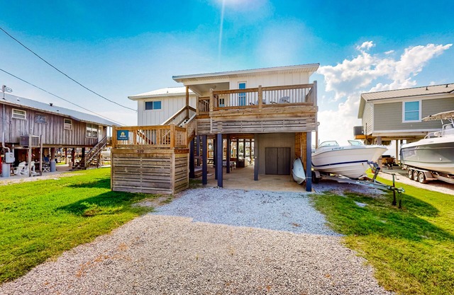 Serene sound-front home with a covered patio, dock, and swing bed
