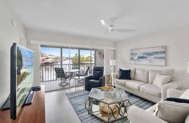 Steps to Vanderbilt Beach | Bright 2BR + Den with Bay Views