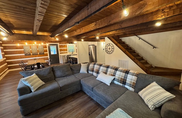 Stunning hand-hewn log cabin blending rustic charm with modern comfort. Minutes from Manchester's dining & shops, yet secluded enough to truly relax. Warm timber beams, cozy furnishings, smart TV & spacious living. 4 bedroom, sleeps 12.