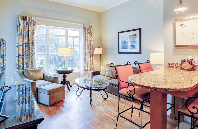 Stylish condo near beach & golf with balcony, W/D, pool, hot tub, & firepit