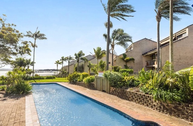 Sunset at The Moorings – newly renovated townhouse on the beach with manicured gardens and pool