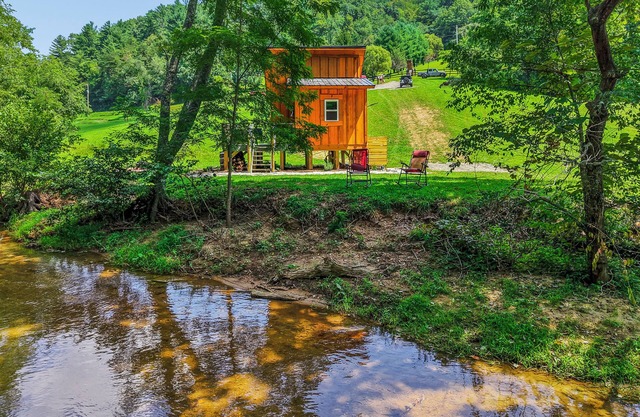 Tiny cabin sits by a bubbling, stocked creek. Pet friendly for a fee, hot tub