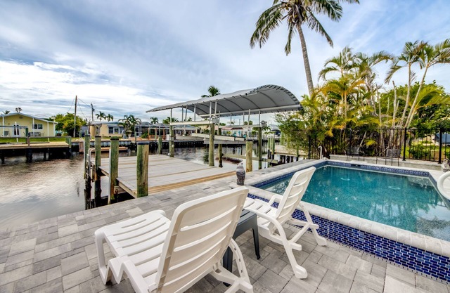 Tropical Oasis Pool Kayak Bikes fish from dock