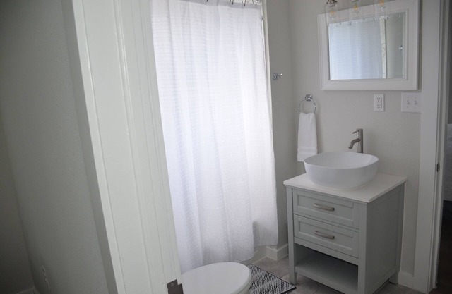 Two bedroom, one bath, modern bungalow with full kitchen and outdoor dining.