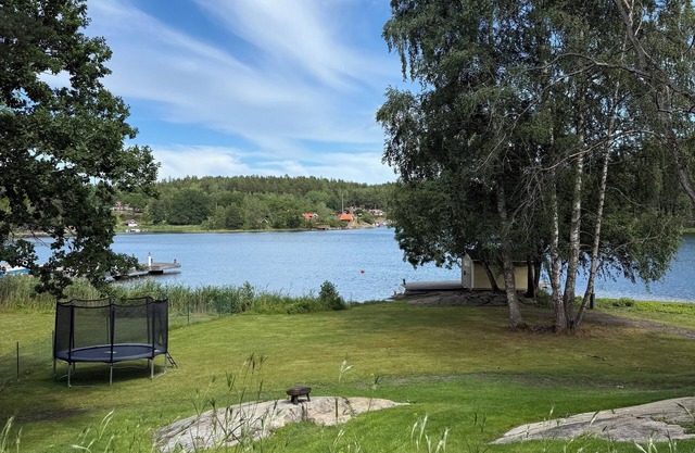 Waterfront home with private beach & hot tub