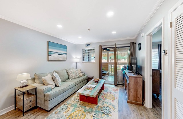 Waterfront villa with resort amenities, beach access, open layout, AC, & W/D