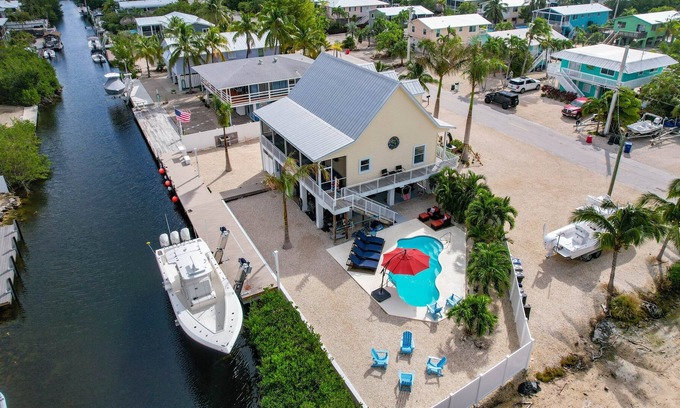 Breezeswept Beach Estates House | 3 Bed/2 Bath Canal Front Home in Ramrod Key 80' Dock and Pool
