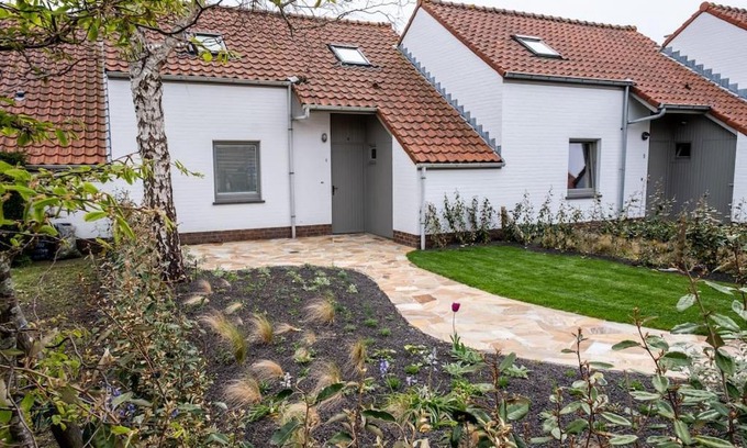 Nieuwpoort House | 'A little white house with a tree by the sea' with beach cabin by BLOSS