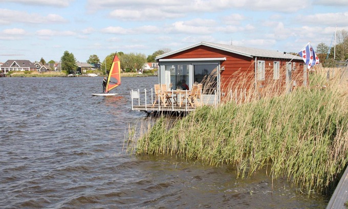Oudega House | Boat "De Frijheit" overlooking the water