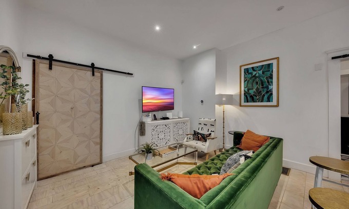 Midtown Apartment | Boho-style 2BR/2BA Midtown triplex with private front patio. King + queen bedrooms, updated kitchen, smart TVs, self check-in, and laundry. Walk to Piedmont Park, Trader Joe’s, and restaurants. Free street parking. No pets.