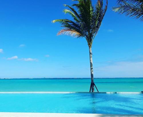 Nassau House | Cable Beach Condo Large private patio with BBQ