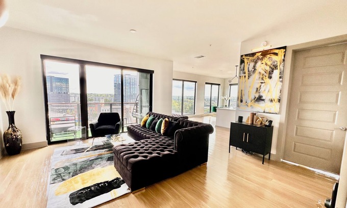 Westside Apartment | Ceiling to floor windows featuring a private balcony with stunning city views! n