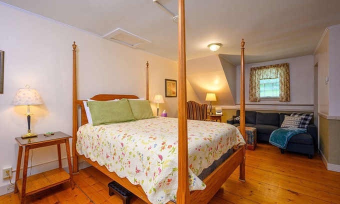 Stowe Bed & Breakfast | Comfortable room with queen bed and twin trundle, a stunning view of Mount Mansfield, sitting area with couch and a parlor stove with full service breakfast included