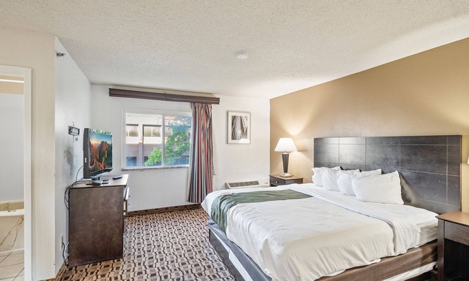 Wichita Hotel | Coratel Suites Deluxe 1 King Suite with Sofa Oversized Non Smoking