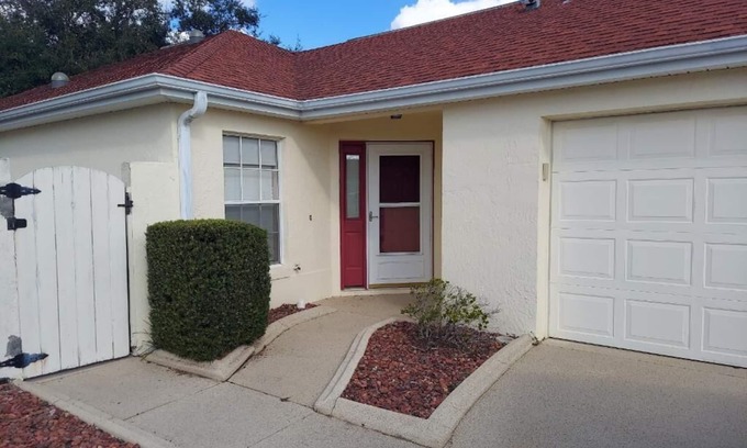 Lady Lake House | Courtyard Villa with gas golf cart located between two Town Squares!