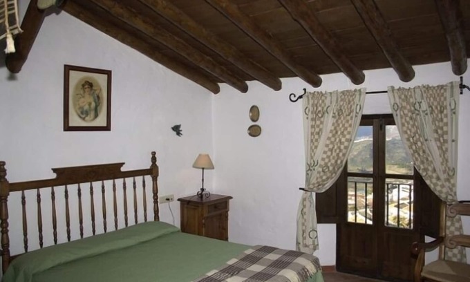 Zahara de la Sierra Cottage | Cozy House in Zahara de la Sierra, Cádiz: Fireplace and Castle Views