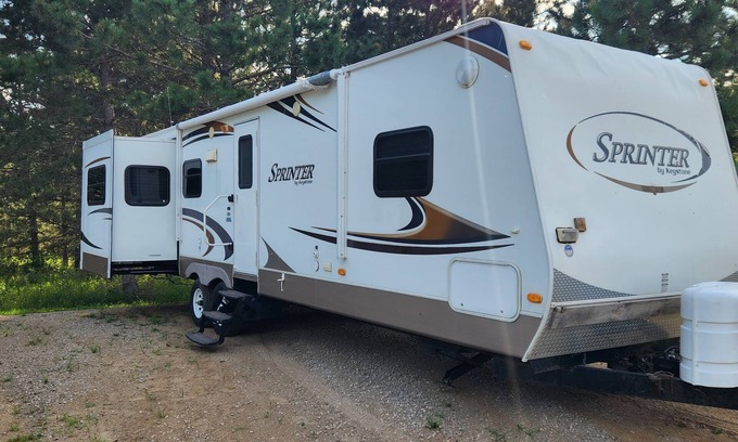 Nevis RV Rental | Deluxe Camper at a RV park