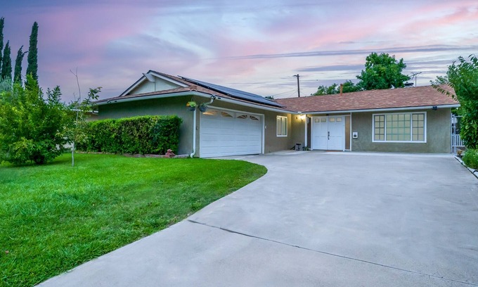 Orange House | Dog-friendly retreat near Disney with enclosed yard, cornhole, central AC, & W/D