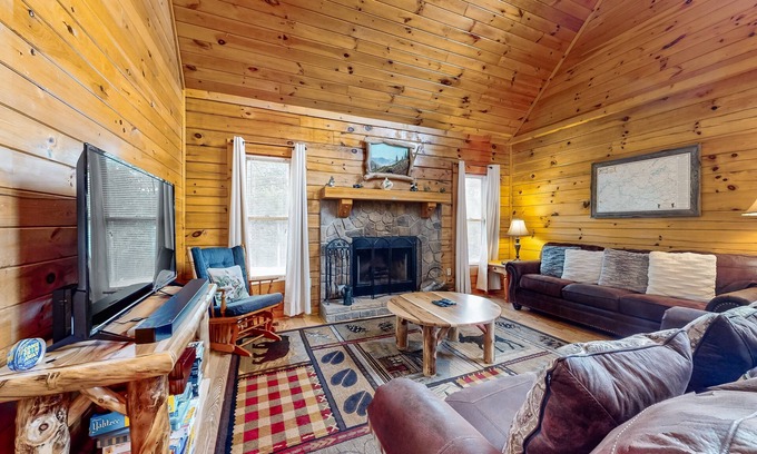 Sevierville Cabin | Forest-view cabin with pool, hot tub, fireplace, deck, & free attraction tickets