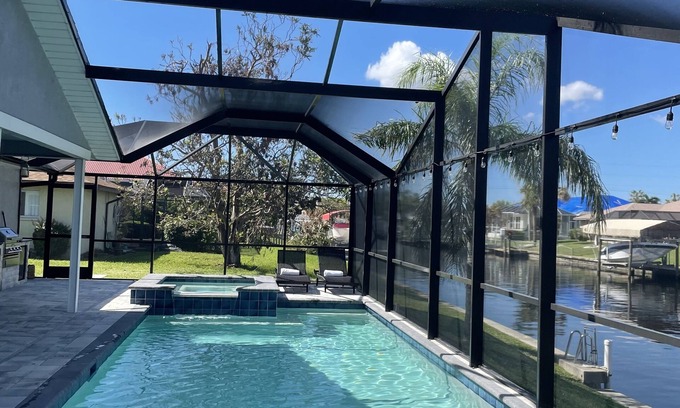 Pelican House | Gulf access pet friendly waterfront oasis with NEW heated salt water pool & spa