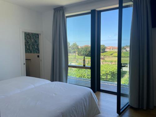 Carracido Hotel | Habitación deluxe rodeada de viñedos