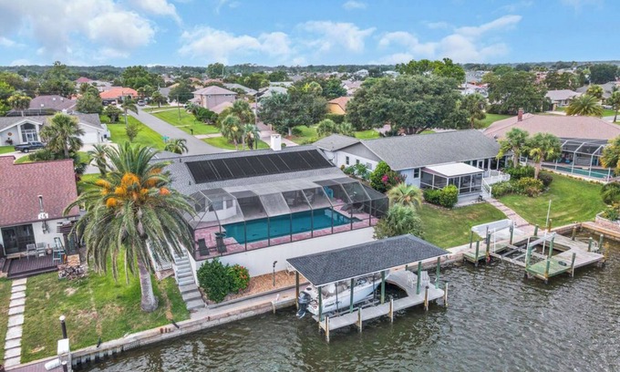 Palm Harbor House | Huge Heated Saltwater Pool, Dock, Games & Waterfront Fun