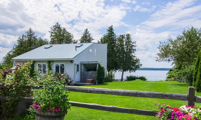 South Hero House | Lakefront Home with Patio Over the Lake, Private Dock, & Stunning Sunset Views